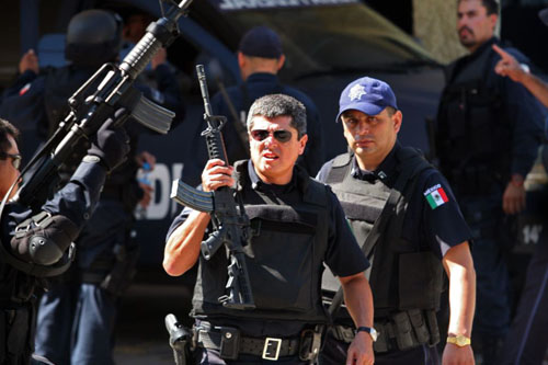 Mexican Federal Police patrol the street